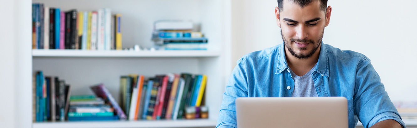 Young man on laptop computer in an office