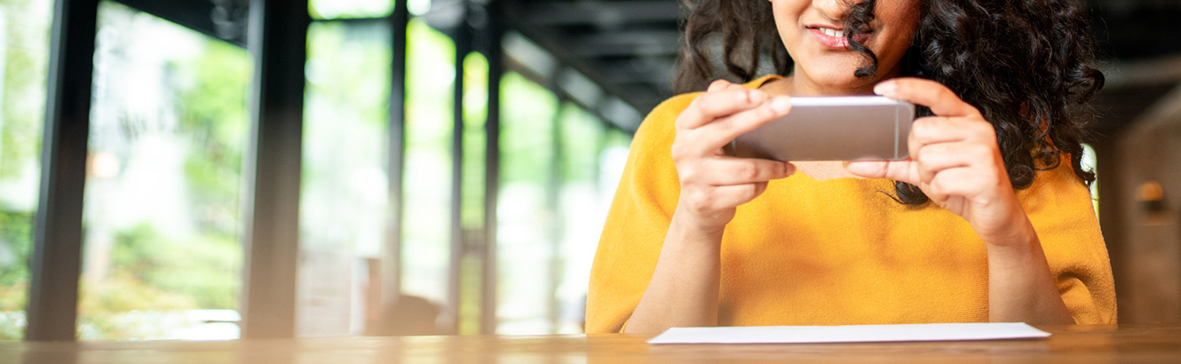 Lady using smartphone to make mobile deposit